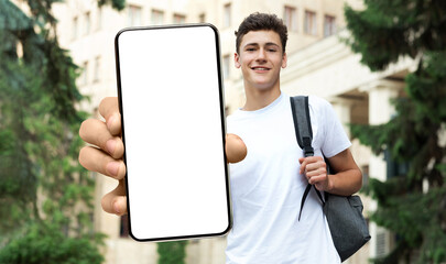 Young male student showing white empty smartphone screen, closeup