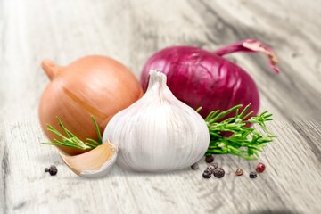 Falling peeled garlic cloves on wooden desk