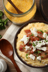 Delicious traditional Ukrainian banosh served on wooden table, flat lay