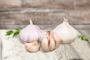 Falling peeled garlic cloves on wooden desk