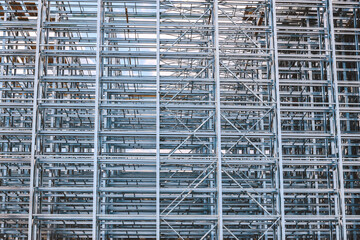 Structure of a new steel frame of a building on an industrial construction site.