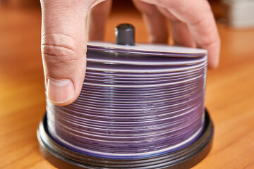 The man folds and counts the disks.