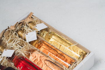 Assortment of 250 ml bottles of red, pink, white wine in box of wooden shavings, no label. Set of...