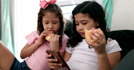 Children eating sandwich snack browsing internet