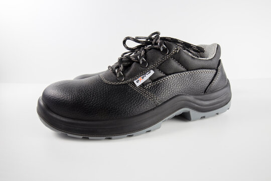 Portugal, February 12, 2022: Pair of white S3 safety shoes on a black background. Exena, Italy company. Isolated Product. 