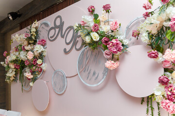Beautiful pink wedding presidium for just married, tender flowers, decorative elements and initials
