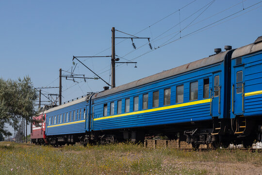 Old blue passenger train, carriages on a sunny summer day