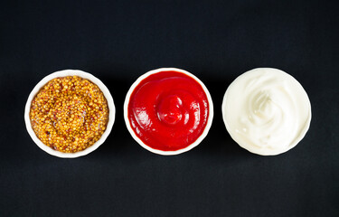 Set sauces ketchup dijon mustard and mayonnaise in bowls