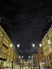 Festive illumination for Christmas and New Year on Malaya Konyushennaya Street in St. Petersburg on an early winter morning