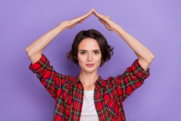 Fototapeta na wymiar Photo of nice millennial brunette lady show roof wear red shirt isolated on purple color background