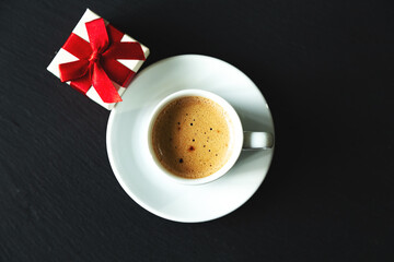 Cup of espresso coffee with gift.