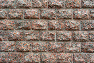 Tiles with a rough texture of gray-brown color, for finishing of a facade of houses.