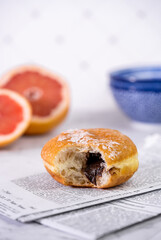 Breakfast with grapefruit and chocolate donut. Copy space. Vertical image
