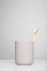 wooden eco friendly toothbrush with cup, bamboo toothbrush on white background