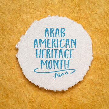 April - Arab American Heritage Month, handwriting on a circular watercolor paper against yellow bark paper, reminder about cultural event