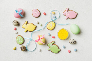 holiday preparation Multi colors Easter eggs with cookies on colored background . Pastel color Easter eggs. holiday concept with copy space