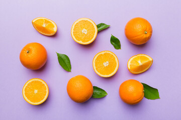 Fruit pattern of fresh orange slices on colored background. Top view. Copy Space. creative summer concept. Half of citrus in minimal flat lay