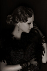 Hollywood. Style 20s or 30s. Young luxury Woman in Retro. Old-fashioned makeup and finger wave hairstyle. Vintage style. Feather boa. Mysterious Luxurious Girl. Finger wave hairstyle. Luxurious Woman