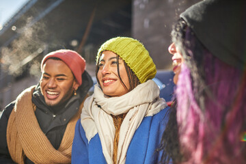 USA, New York City, Smiling friends in city on cold sunny day - Powered by Adobe