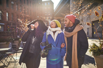 USA, New York City, Smiling friends on street on cold day