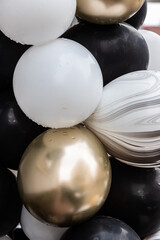 black, silver and gold balloons. background close-up