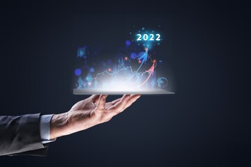 Hand holding increase arrow graph corporate future growth in year 2022. Planning,opportunity, challenge and business strategy.