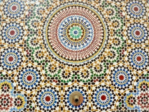 Close up traditional fountain, colorful glazes ceramic wall tiles in Islamic design. Rabat, Morocco.