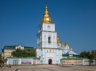Fototapeta na wymiar Tower, bell tower and entrance of St. Michael's Golden Domed Monastery. Comprises the cathedral itself in Kiev, the capital of Ukraine. Famous religious place in Ukraine