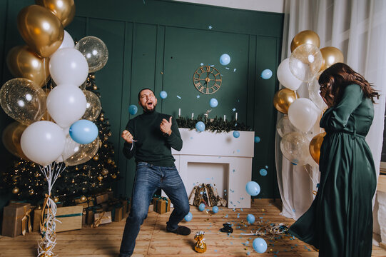 A stylish, bearded man and a cute, beautiful pregnant brunette girl rejoice when they find out that they will have a boy. Gender party.