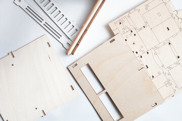 small ready-made wooden blanks for assembling a dollhouse on a white background