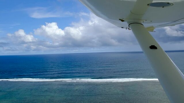 View of mauritius ocean coast, underwater watefall and Le Morne mountain from float plane cabin