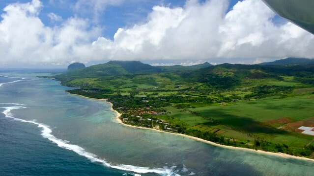 View of mauritius ocean coast, underwater watefall and Le Morne mountain from float plane cabin