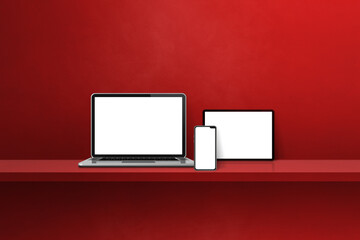 Laptop, mobile phone and digital tablet pc on red wall shelf. Horizontal background