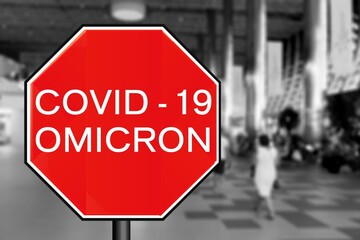 Covid-19concept with stop sign with passengers arriving at passport control within generic airport