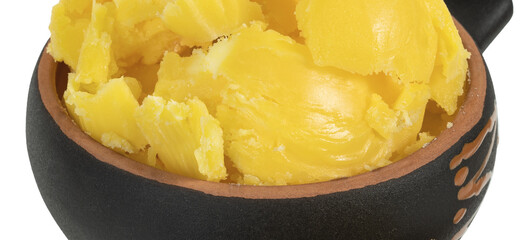 Melted butter in a cup on a white background.