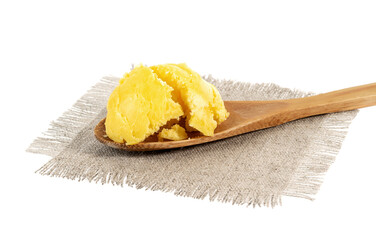 ghee in a spoon on burlap, white background. Pure ghee.