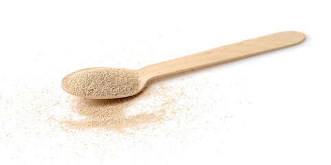 Dry yeast in wooden scoop isolated on white background