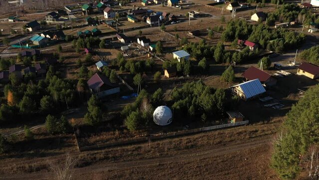 Geo dome and houses in Chemal village in Altai mountains, aerial view, tourist destination of Russia
