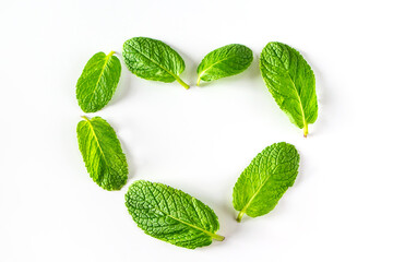 Heart made from green mint leaves. Green valentines day concept. Freshly fragrant plant for making...