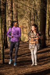 Obraz premium Young women walking in forest