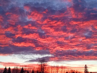 Fototapeta premium Fiery Red Sunset Reflecting off Clouds