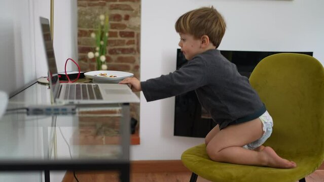Baby boy wearing diapers in front of laptop at home 2 year old toddler