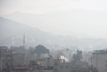 Selcuk city is under the fog at early winter morning, Turkey