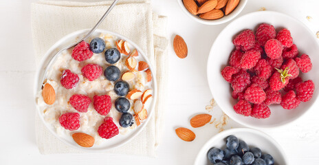 Oatmeal porridge with raspberries, blueberries and nuts