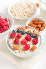 Oatmeal porridge with raspberries, blueberries and nuts