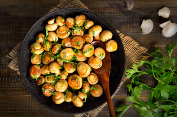 Delicious fried mushrooms in cast iron pan