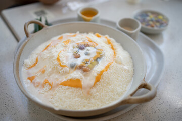 Salty Egg Yolk Bua-Loi Bingsu. Dessert on a table at cafe. korean shaved ice dessert 