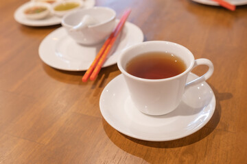 Hot herbal red tea in a cup on a table at restaurant.