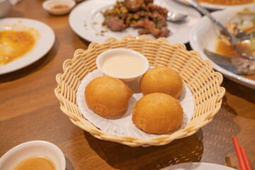 Fried Chinese buns stuff custard cream served with condensed sweet milk. Asian food style.