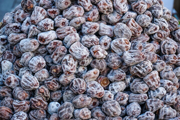 Pile of fresh date fruit. Pile of date fruit on the table. Group of date fruits. Healthy date fruits concept. 